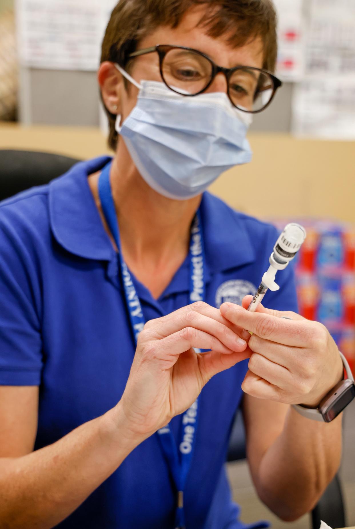 Dana Rynk, a Mecklenburg County Public Health nurse, prepares a needle with the monkeypox vaccine at a vaccination clinic in Charlotte, N.C., Saturday, Aug. 20, 2022.