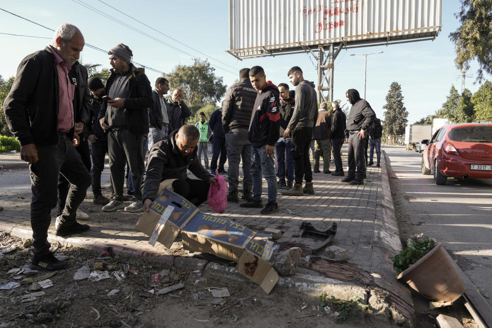 People inspect the site where six Palestinians were killed by an Israeli airstrike in the West Bank city of Jenin on Sunday, Jan. 7, 2024. Six Palestinians and a member of Israel's paramilitary border police were killed in confrontations in a hot spot of violence in the Israeli-occupied West Bank, the Palestinian Health Ministry and the Israeli military said Sunday. (AP Photo/Majdi Mohammed)