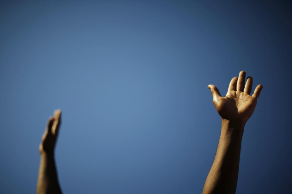 A protester's raised arms are pictured during a march, following the Monday grand jury decision in the shooting of Michael Brown in Ferguson, Missouri, in Los Angeles, California November 25, 2014. U.S. President Barack Obama said on Tuesday anyone who destroys property in rioting against a Missouri grand jury's decision should be prosecuted, urging Americans upset by the court to work together to improve race relations. REUTERS/Lucy Nicholson (UNITED STATES - Tags: CIVIL UNREST CRIME LAW POLITICS TPX IMAGES OF THE DAY)