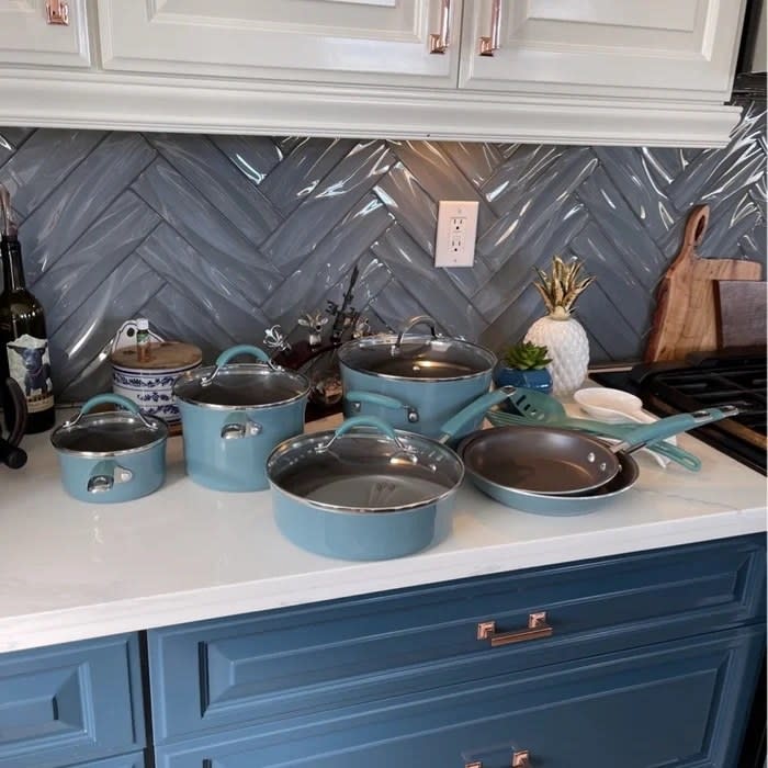 A set of blue pans and pots in a reviewer's home