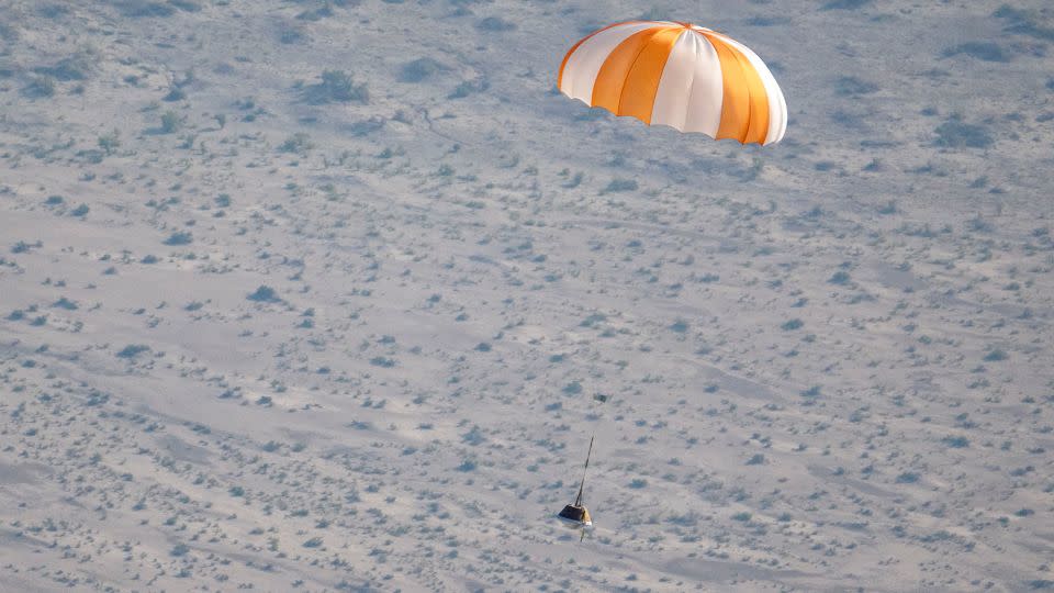 A training model of the sample return capsule is seen during a drop test. Parachutes will slow the capsule's descent. - Keegan Barber/NASA