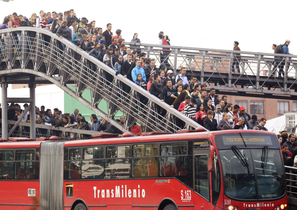 Passengers wait for a Transmilenio system bus during rush hour in Bogota, March 12, 2014. A Thomson Reuters Foundation survey of 15 of the world's largest capitals and New York found Bogota in Colombia ranked as having the most unsafe public transport, with women scared to travel after dark, followed by Mexico City, Lima, then Delhi. Picture taken March 12, 2014. To match Thomson Reuters Foundation story WOMEN/POLL       REUTERS/Jose Miguel Gomez   (COLOMBIA - Tags: SOCIETY TRANSPORT TPX IMAGES OF THE DAY)