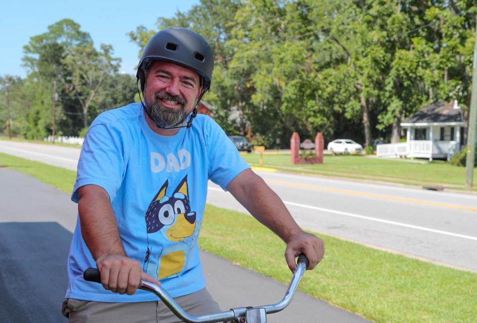 Guyton Mayor Russ Deen rides his bicycle on a trail just across from Guyton City Hall.