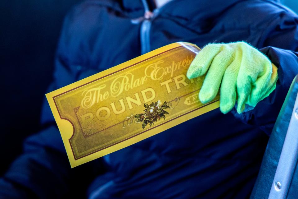 A passenger holds his golden ticket on "The Polar Express Train Ride" at the Oklahoma Railway Museum.