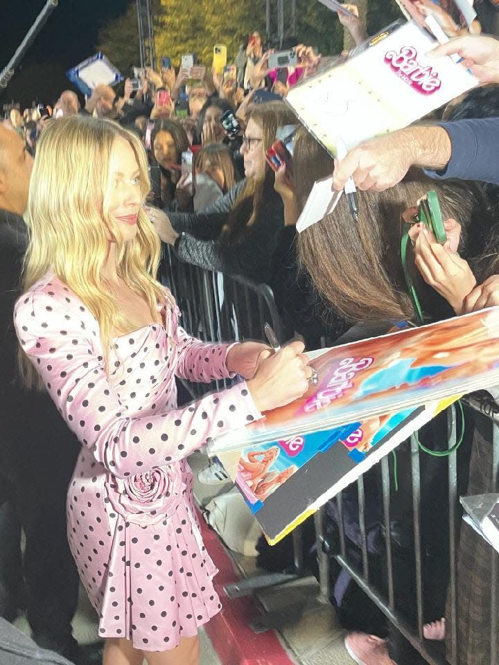 Margot Robbie, star of "Barbie," takes photos with fans at the Palm Springs International Film Awards in Palm Springs, Calif. on Thursday, Jan. 4, 2024.