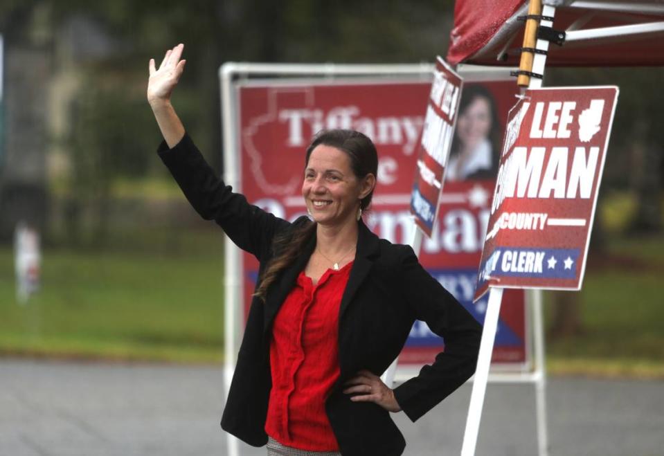 Tiffany Lee Cowman waves at vehicles near City Hall in Diamondhead on Aug. 29, 2023. Cowman is a Republican candidate for Hancock County chancery clerk.