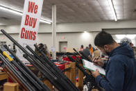 FILE - Ivan Gonzalez fills out paperwork while purchasing a gun at the Silver Spur Gun and Blade Show, Saturday, Jan. 23, 2021, in Odessa, Texas. After a year of pandemic lockdowns, mass shootings are back, but the guns never went away. As the U.S. inches toward a post-pandemic future, guns are arguably more present in the American psyche and more deeply embedded in American discourse than ever before. The past year's anxiety and loss fueled a rise in gun ownership across political and socio-economic lines. (Eli Hartman/Odessa American via AP, File)