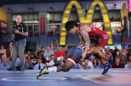 U.S. wrestler Jordan Burroughs (L) spars with Japanese wrestler Sohsuke Takatani at the "Beat The Streets" wrestling event in Times Square, New York City, U.S., May 17, 2017. REUTERS/Joe Penney