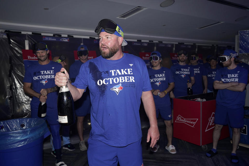 Toronto Blue Jays celebrate in the locker room after clinching a berth in the AL wild card series following a baseball game against the Tampa Bay Rays in Toronto, Sunday, Oct. 1, 2023. (Frank Gunn/The Canadian Press via AP)