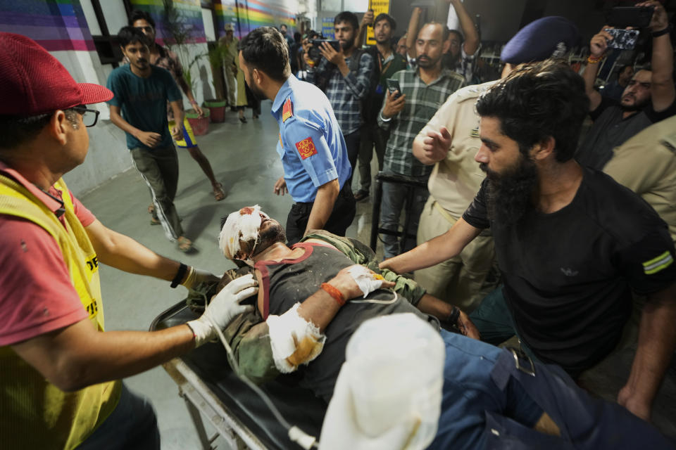 An injured man is brought to the Government Medical College Hospital in Jammu after the bus he was traveling in fell into a deep gorge in the Pouni area of Jammu's Reasi district, India, Sunday, June 9, 2024. Officials in Indian-controlled Kashmir say at least nine people have been killed after suspected militants fired at a bus with Hindu pilgrims, which then fell into a deep gorge. (AP Photo/Channi Anand)