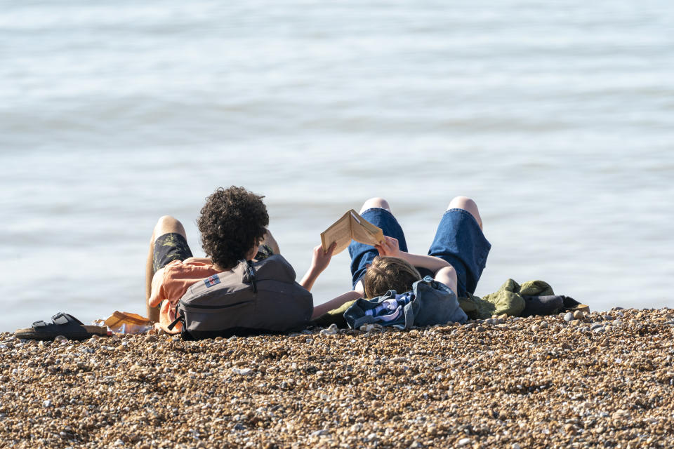 BRIGHTON, ENGLAND - MARCH 30: People take advantage of the unseasonably warm weather and relaxing of lockdown restrictions to go to the beach on March 30, 2021 in Brighton, England. Parts of the UK are set to see the warmest day of the year so far as forecasters are predicting temperatures of 22C (72F). With the easing of pandemic lockdown rules, many people will be heading for the outdoors. (Photo by Chris Eades/Getty Images)