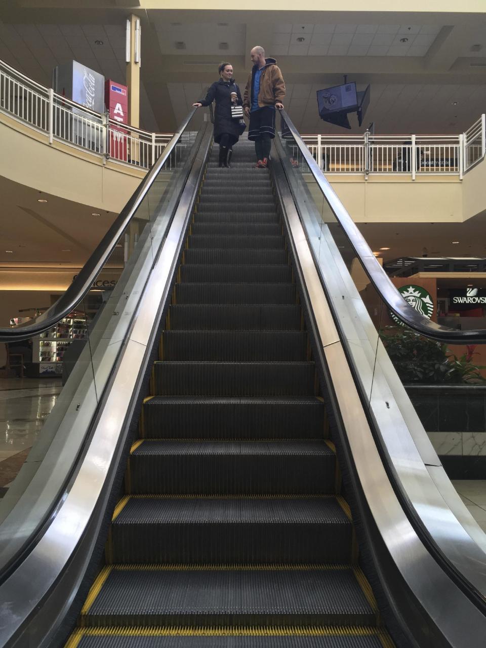 Courtney Taylor and her boyfriend, Zach Tobias, ride the escalator at a mall in Whitehall, Pa., on Feb. 9, 2017. Taylor and Tobias don’t mix shopping with politics, but say it seems to be happening more often during the Donald Trump era as activists who either oppose or support the president target stores and brands for boycotts. (AP Photo/Michael Rubinkam)