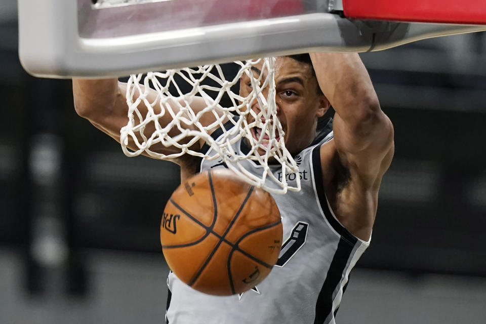 San Antonio Spurs forward Keldon Johnson (3) scores against the Boston Celtics during the second half of an NBA basketball game in San Antonio, Wednesday, Jan. 27, 2021. (AP Photo/Eric Gay)