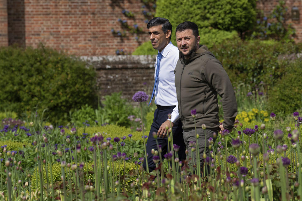 FILE - Britain's Prime Minister Rishi Sunak, left, and Ukraine's President Volodymyr Zelenskyy, walk in the garden at Chequers, the prime minister's official country residence, in Aylesbury, England, Monday, May 15, 2023. While the world awaits Ukraine's spring offensive, its leader Volodymyr Zelenskyy has already launched a diplomatic one. In a span of a week, he has dashed to Italy, the Vatican, Germany, France and Britain to shore up support for the defense of his country. On Friday, May 19, 2023, he was in Saudi Arabia to meet with Arab leaders, some of whom are allies with Moscow. (Carl Court/Pool via AP, File)