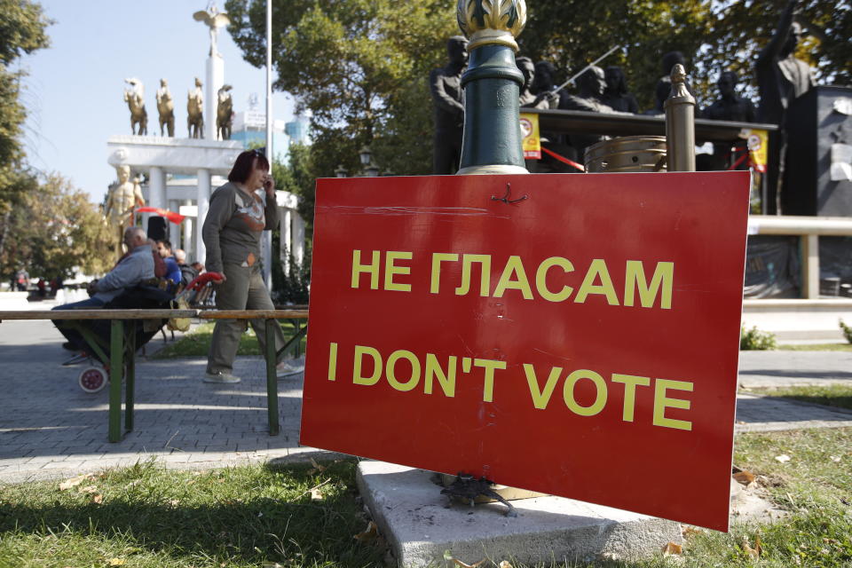 A poster by opponents to the referendum hangs in downtown Skopje, Macedonia, Sunday, Sept. 30, 2018. Macedonians were deciding Sunday on their country's future, voting in a crucial referendum on whether to accept a landmark deal ending a decades-old dispute with neighbouring Greece by changing their country's name to North Macedonia, to qualify for NATO membership and also pave its way toward the European Union. (AP Photo/Thanassis Stavrakis)