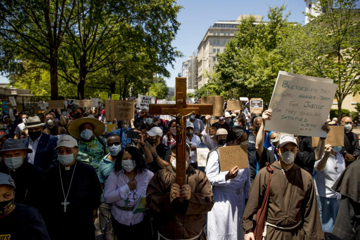 Members of the Archdiocese of Washington march from the White House to the Smithsonian National Museum of African American History and Culture, Monday, June 8, 2020, in Washington, after days of protests over the death of George Floyd, a black man who was in police custody in Minneapolis. Floyd died after being restrained by Minneapolis police officers. (AP Photo/Andrew Harnik)