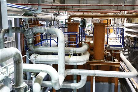 An employee of OPC Rotem, Israel's biggest private power plant, running on gas from the Tamar field, stands inside the turbine room at the company's new power plant in Mishor Rotem industrial area in Israel's southern Negev desert, in this November 12, 2013 file picture. REUTERS/Amir Cohen/Files