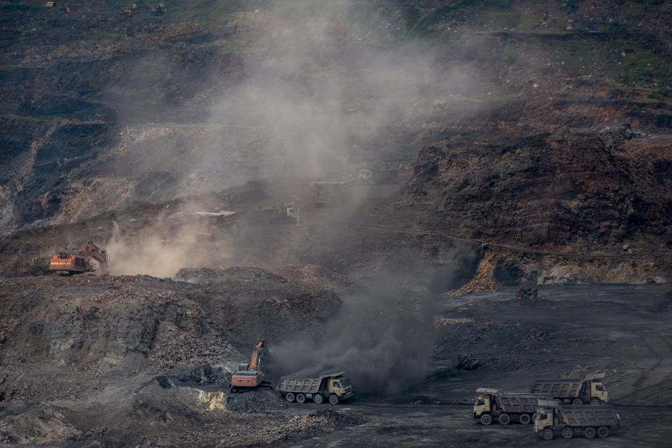 Mining is in progress at an open-cast mine near Dhanbad, an eastern Indian city in Jharkhand state, Friday, Sept. 24, 2021. No country will see energy needs grow faster in coming decades than India, and even under the most optimistic projections part of that demand will have to be met with dirty coal power — a key source of heat-trapping carbon emissions. (AP Photo/Altaf Qadri)