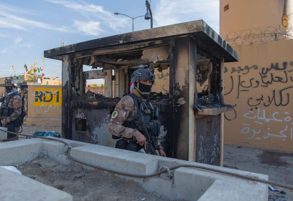 Iraqi army soldiers are deployed in front of the U.S. embassy, in Baghdad, Iraq, Wednesday, Jan. 1, 2020.