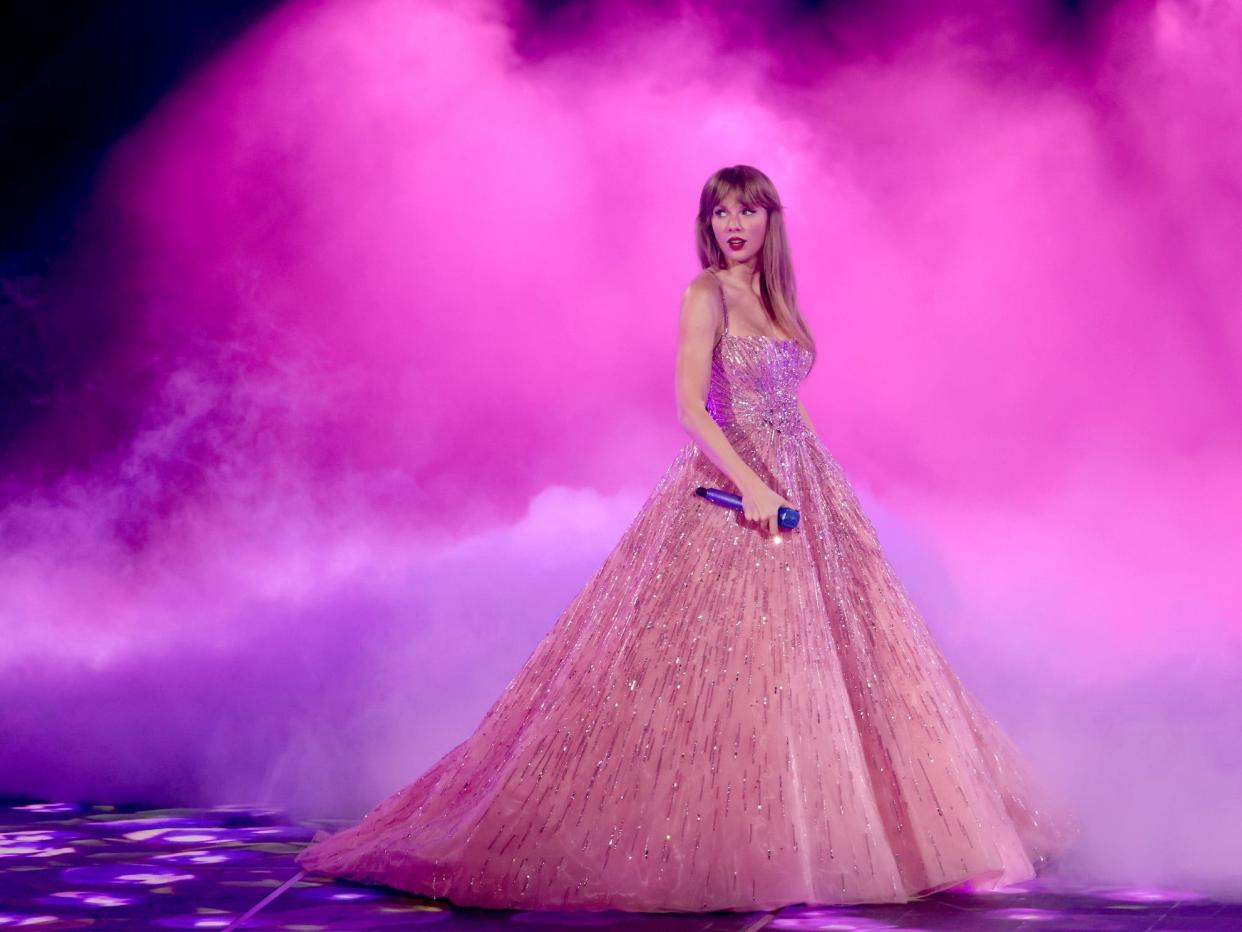 Taylor Swift performs in a pink ball gown.