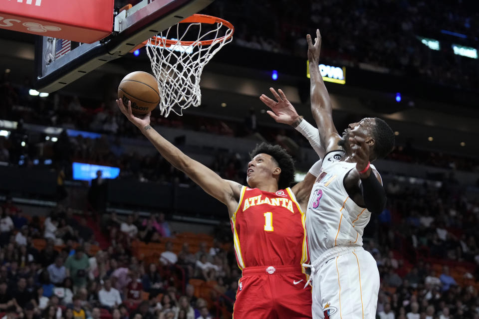 Atlanta Hawks guard Donovan Williams (4) goes up for a shot against Miami Heat center Bam Adebayo (13) during the first half of an NBA basketball game, Monday, March 6, 2023, in Miami. (AP Photo/Wilfredo Lee)