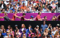 Fellow volunteer "cheerleaders." The crowd dance a Conga on Day 3 of the London 2012 Olympic Games at Horse Guards Parade on July 30, 2012 in London, England. (Ryan Pierse/Getty Images)