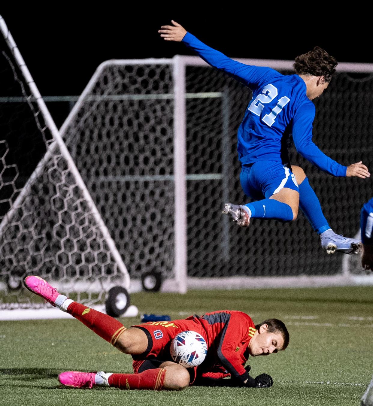 Olentangy's John Hargett makes a save Sept. 14 as Olentangy Berlin's Ethan Thomas leaps to avoid the diving goalie.