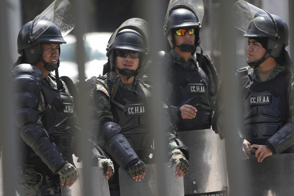 Soldiers stand guard outside the National Assembly the day after the body was disolved by President Guillermo Lasso in Quito, Ecuador, Thursday, May 18, 2023. Lawmakers were moving forward with impeachment proceedings against the president on embezzlement charges when he disolved it, and now residents are expected to elect a new president and a new lawmakers in no more than 90 days. (AP Photo/Dolores Ochoa)