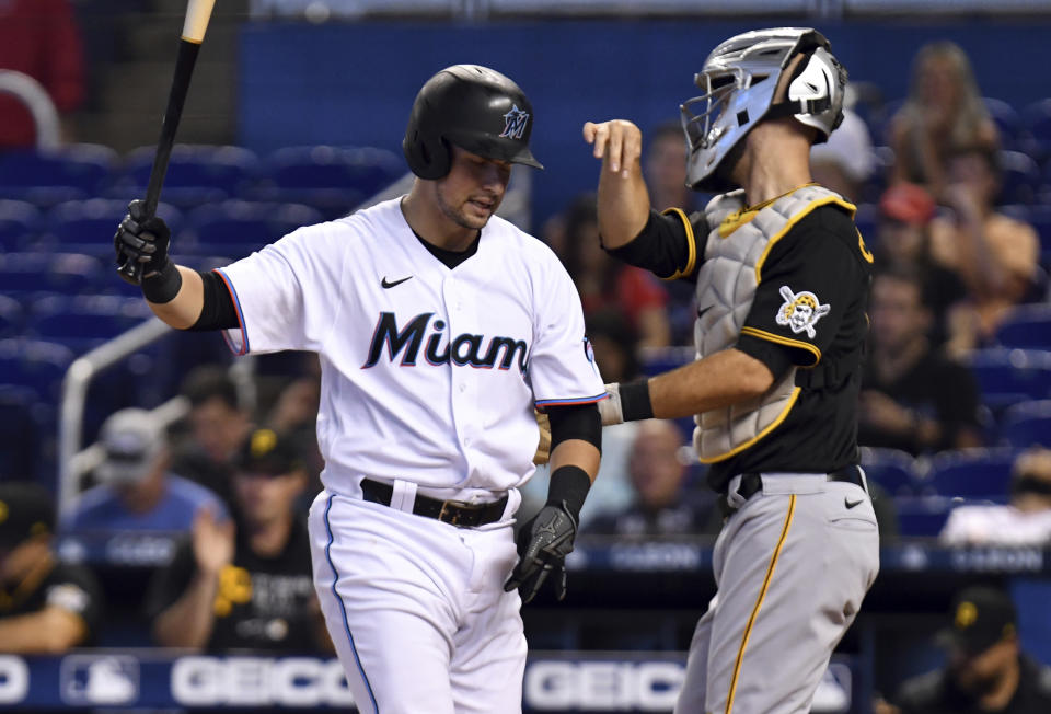 Miami Marlins' Joe Panik, left, reacts after striking out during the second inning of a baseball game against the Pittsburgh Pirates, Sunday, Sept. 19, 2021, in Miami. (AP Photo/Jim Rassol)