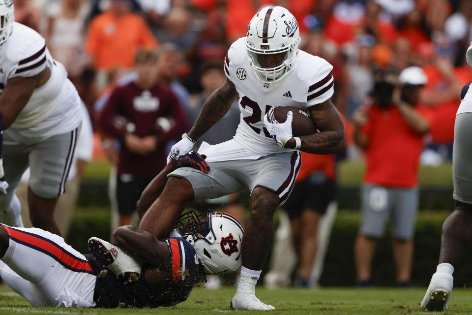 Auburn linebacker Eugene Asante (9) tackles Mississippi State running back Jeffery Pittman (25) for a loss as during the first half an NCAA college football game, Saturday, Oct. 28, 2023, in Auburn, Ala. (AP Photo/Butch Dill)