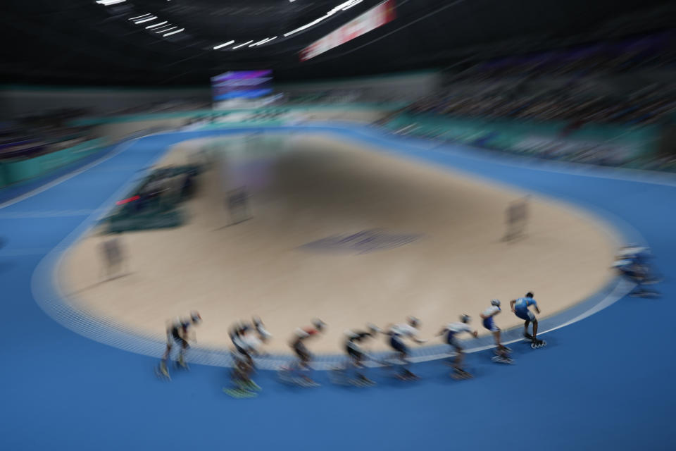Athletes compete during the men's Speed Skating 10000m Point-Elimination Race event of the 19th Asian Games in Hangzhou, China, Saturday, Sept. 30, 2023. (AP Photo/Aaron Favila)
