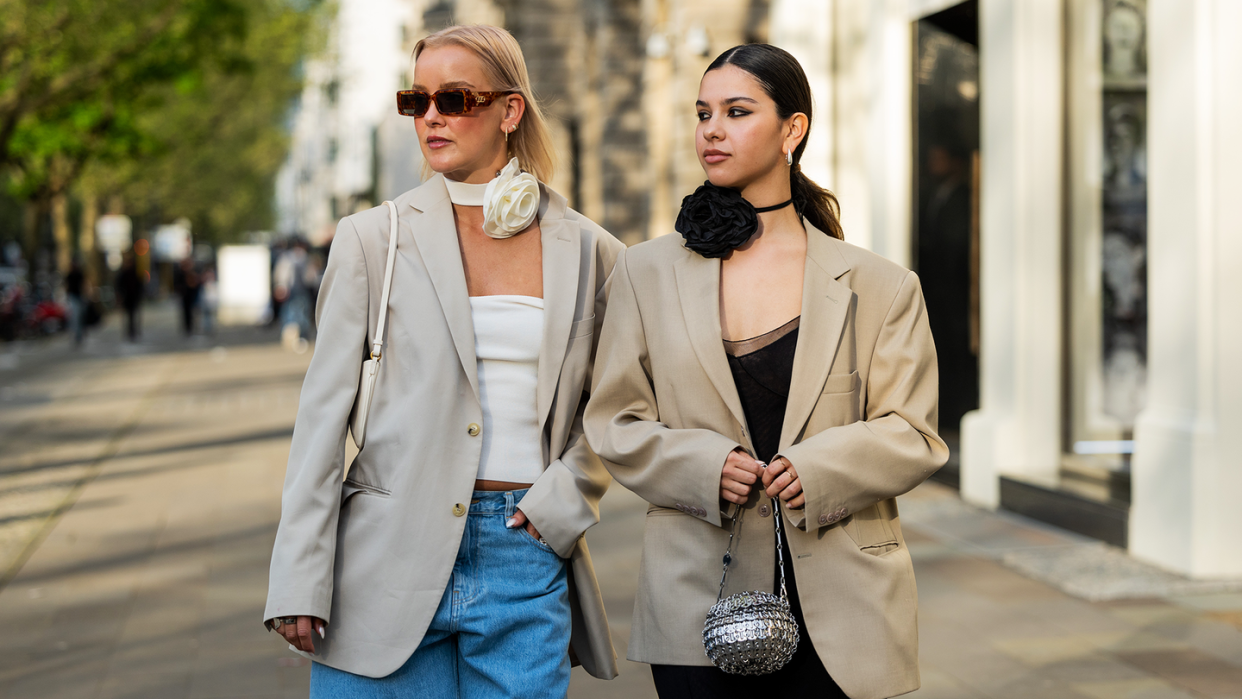 two women in blazers and flower neck ties