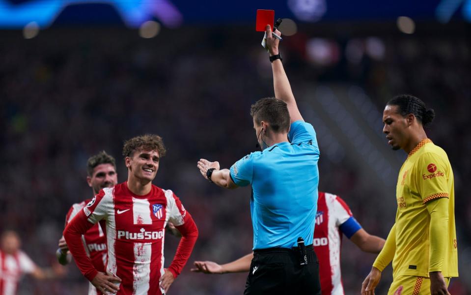 Referee Daniel Siebert shows a red card to Antoine Griezmann of Atletico de Madrid during the UEFA Champions League group B match between Atletico de Madrid and Liverpool FC at Wanda Metropolitano on October 19, 2021 in Madrid, Spain. - GETTY IMAGES