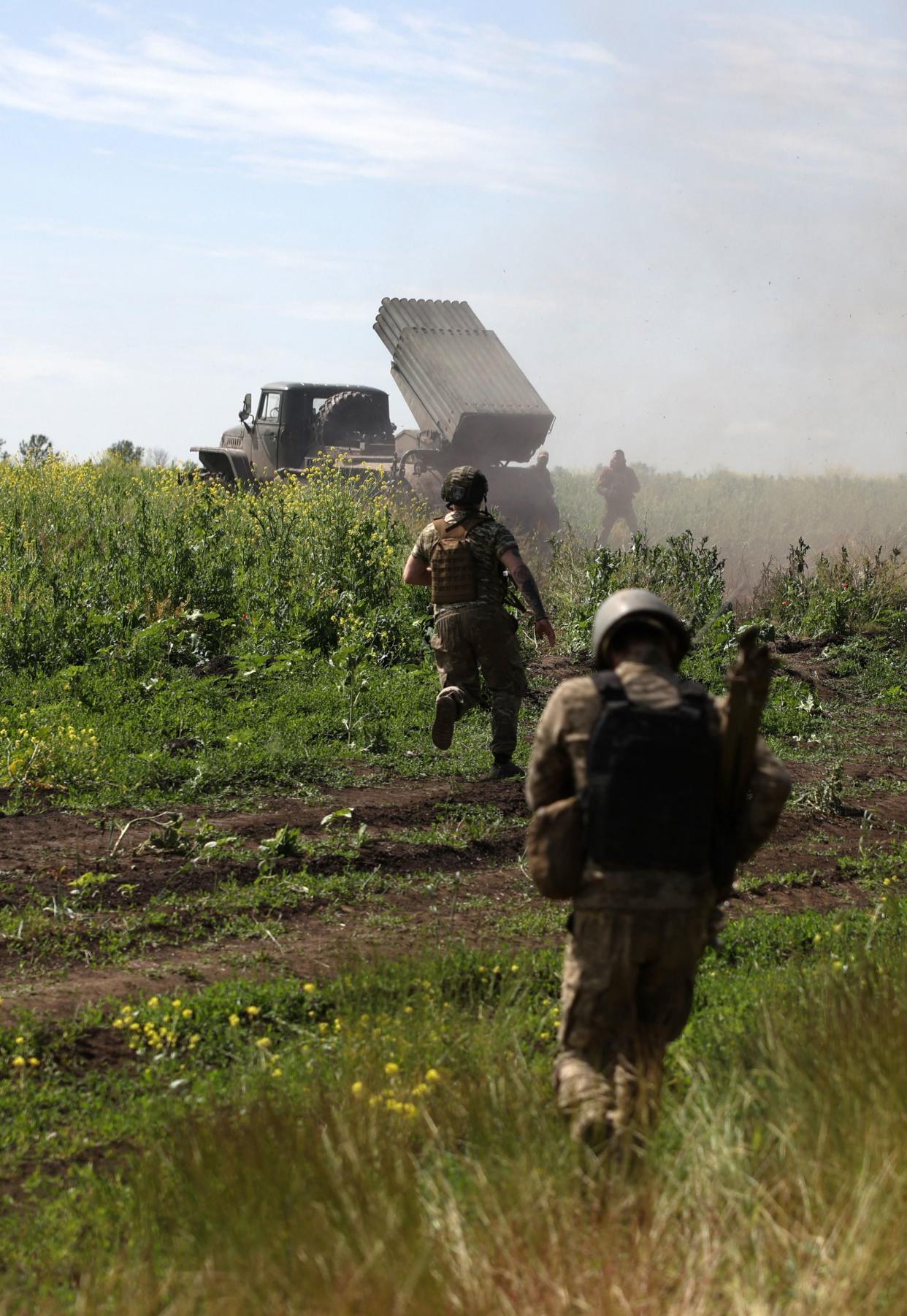 Ukrainian servicemen of the 10th Mountain Assault Brigade “Edelweiss” shift position after firing rockets from a BM-21 ‘Grad’ multiple rocket launcher towards Russian positions, near Bakhmut (AFP via Getty Images)