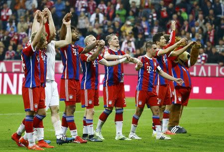 Bayern Munich players acknowledge their fans after winning their German Bundesliga first division soccer match against Hertha Berlin in Munich April 25, 2015. REUTERS/Kai Pfaffenbach