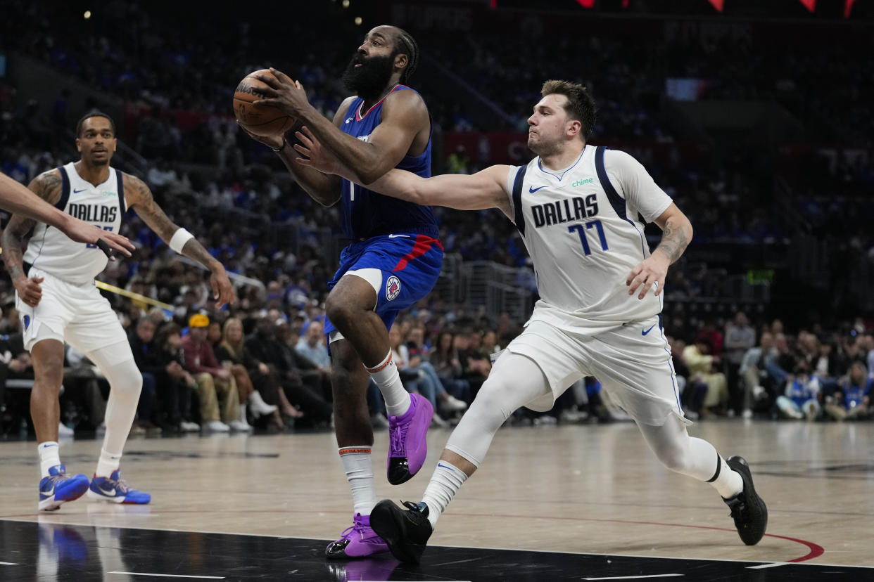 Dallas Mavericks guard Luka Doncic (77) defends against LA Clippers guard James Harden (1) during the first half of Game 1 of an NBA basketball first-round playoff series in Los Angeles, Sunday, April 21, 2024. (AP Photo/Ashley Landis)