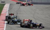 Toro Rosso Formula One driver Daniel Ricciardo (R) of Australia drives ahead of Mercedes Formula One driver Nico Rosberg (C) of Germany and Lotus Formula One driver Heikki Kovalainen of Finland during the Austin F1 Grand Prix at the Circuit of the Americas in Austin November 17, 2013.