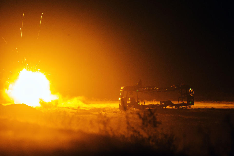 <p>A rocket fired by U.S. soldiers from Dragon Troop of the 3rd Cavalry Regiment explodes next to a destroyed bus at operating base Gamberi in the Laghman province of Afghanistan Dec. 31, 2014. (Photo: Lucas Jackson/Reuters) </p>