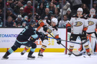 Anaheim Ducks defenseman Cam Fowler (4) moves the puck away from Seattle Kraken right wing Jordan Eberle (7) during the second period of an NHL hockey game Thursday, March 28, 2024, in Seattle. (AP Photo/Jason Redmond)