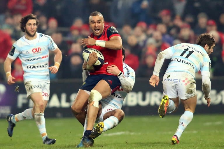 Munster's full-back Simon Zebo (C) is tackled during their European Rugby Champions Cup pool 1 match against Racing 92, at Thomond Park in Limerick, Ireland, on January 21, 2017