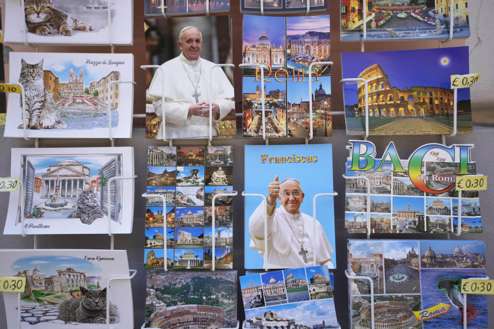 Postcards, some with photographs of Pope Francis, are on sale around St. Peter's Basilica at The Vatican in Rome, Thursday, June 8, 2023, the day after Pope Francis underwent surgery to repair a hernia in his abdominal wall, the latest malady to befall the 86-year-old pontiff who had part of his colon removed two years ago. (AP Photo/Alessandra Tarantino)