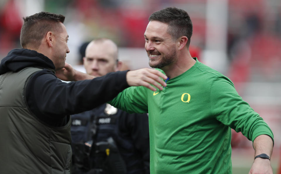 SALT LAKE CITY, UT - OCTOBER 28:  Dan Lanning head coach of the Oregon Ducks greets a supporter after their game againt the Utah Utes at Rice Eccles Stadium on October 28, 2023 in Salt Lake City, Utah.  (Photo by Chris Gardner/Getty Images)