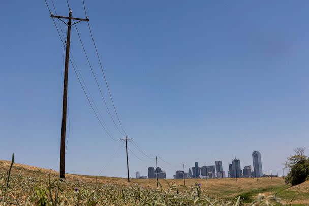 PHOTO: Utility poles lead to downtown Dallas during a heat advisory due to scorching weather in Dallas, Texas, July 12, 2022. (Shelby Tauber/Reuters)