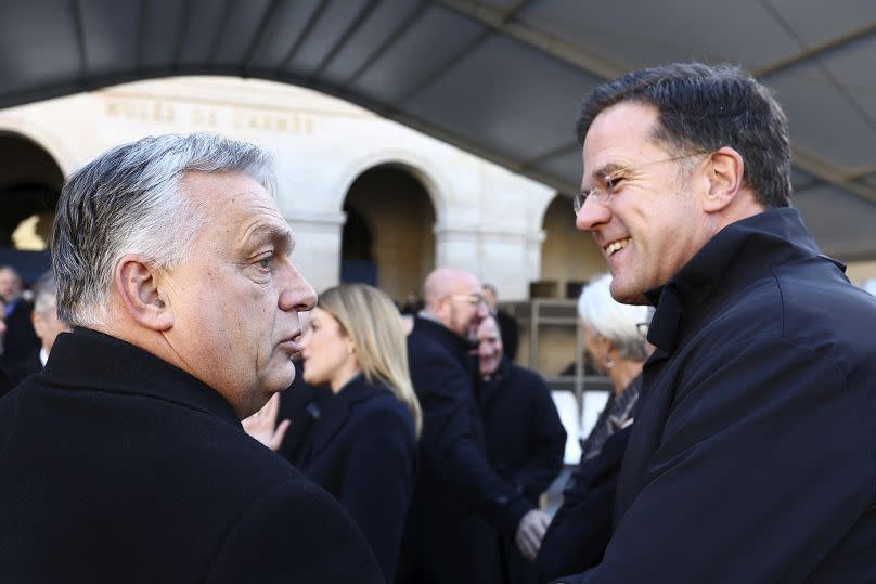 Hungary's Prime Minister Viktor Orban, left, talks with Netherlands' Prime Minister Mark Rutte.