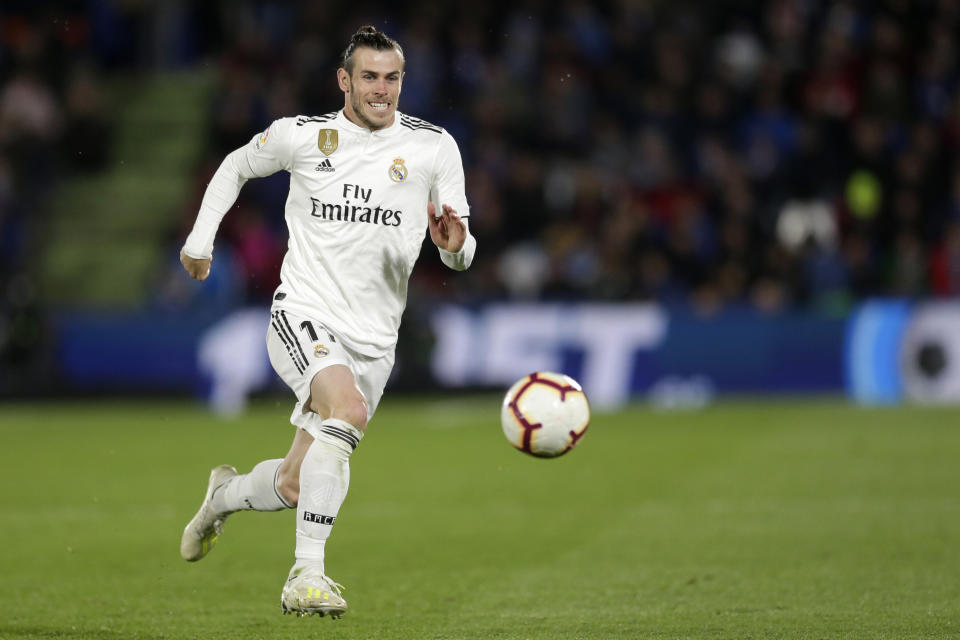 Real Madrid's Gareth Bale goes for the ball during a Spanish La Liga soccer match between Getafe and Real Madrid at the Alfonso Perez stadium in Getafe, Spain, Thursday, April 25, 2019. (AP Photo/Bernat Armangue)