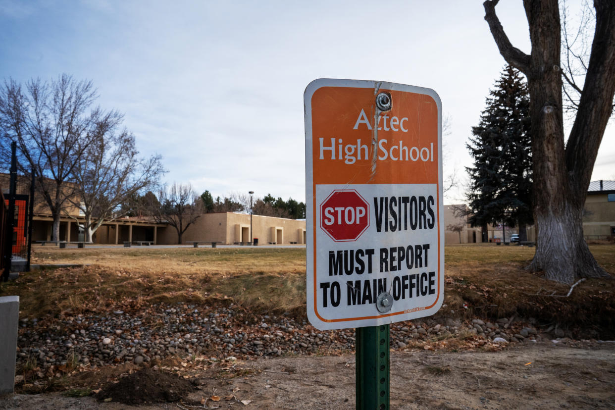 Outside Aztec High School, a sign instructs visitors to check in with the office. The shooter walked in through an unlocked door in 2017. (NBC News)