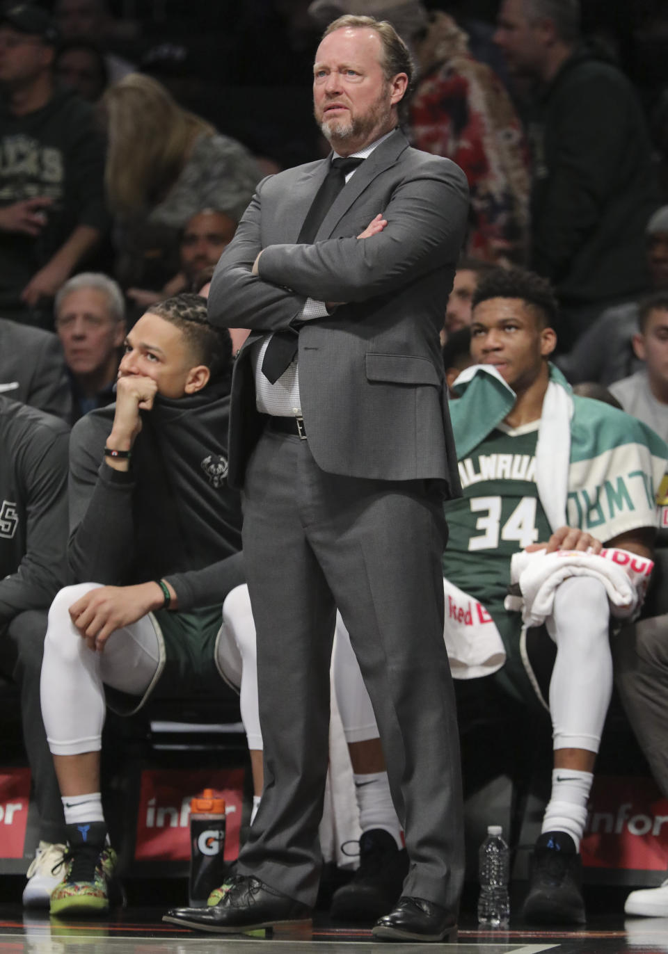 Milwaukee Bucks forward Giannis Antetokounmpo, right, sits with foul trouble early as head coach Mike Budenholzer, center, monitor action, during a NBA basketball game against the Brooklyn Nets, Saturday, Jan. 18, 2020, in New York. (AP Photo/Bebeto Matthews)