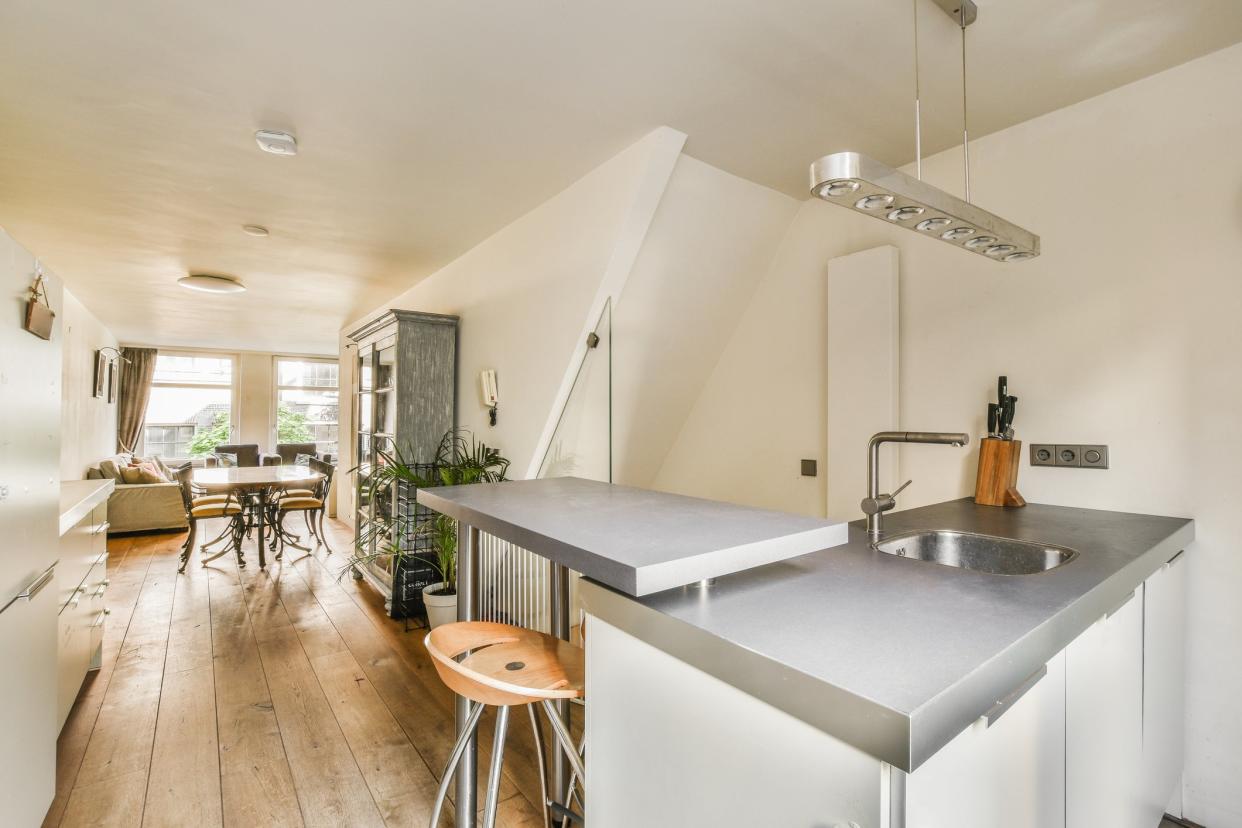 A modern kitchen with countertops at two different levels counter height and bar height.