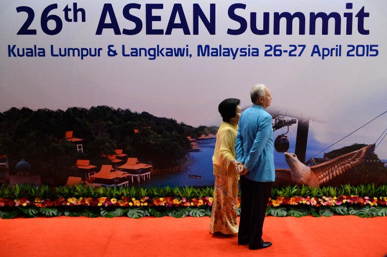 Malaysian Prime Minister Najib Razak (R) and his wife Rosmah Mansor (L) wait for a group photo before a gala dinner in honour of ASEAN heads of state, in Kuala Lumpur on April 26, 2015