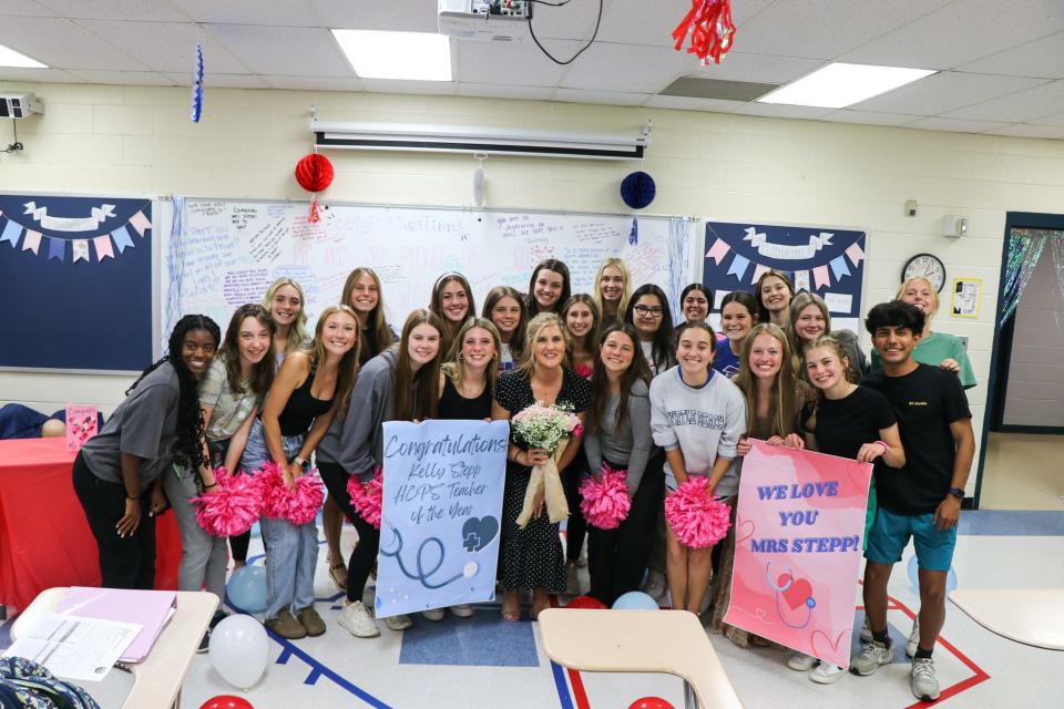 West Henderson High teacher Kelly Stepp poses with her class on May 9 after she was named the 2024 Henderson County Public Schools Teacher of the Year.